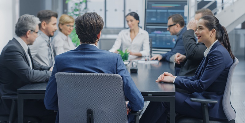 Board members in suits at a desk