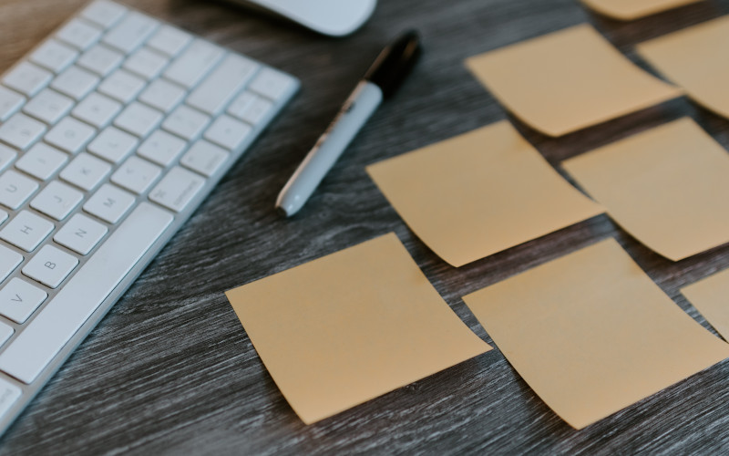 brown sticky notes on a desk with a keyboard