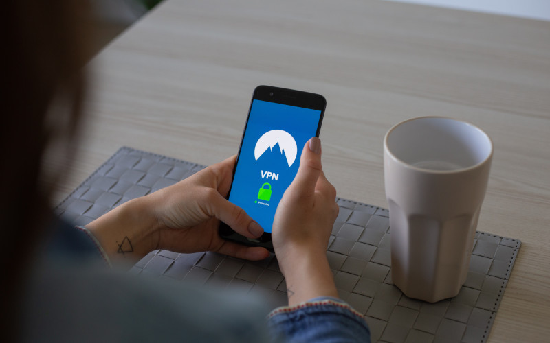 Person holding smart phone logging into a VPN