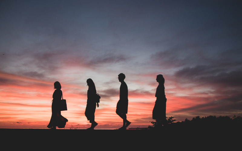 silhouette of a group of people on a mountain