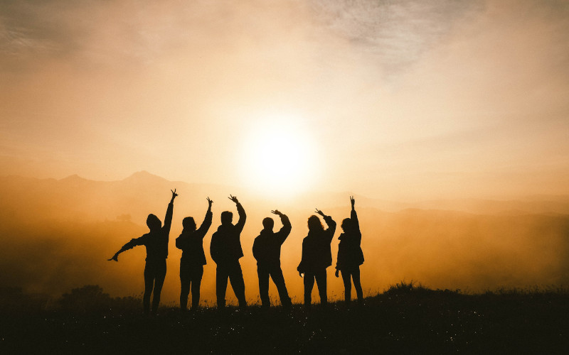 silhouette of a group of people on a mountain