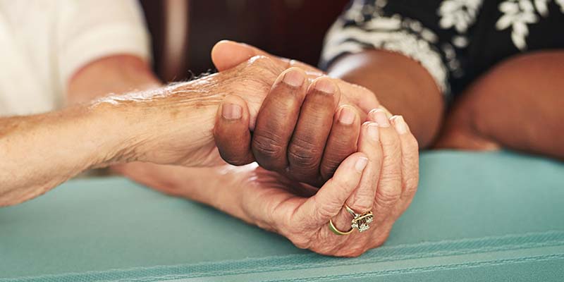 old and young hands clasping