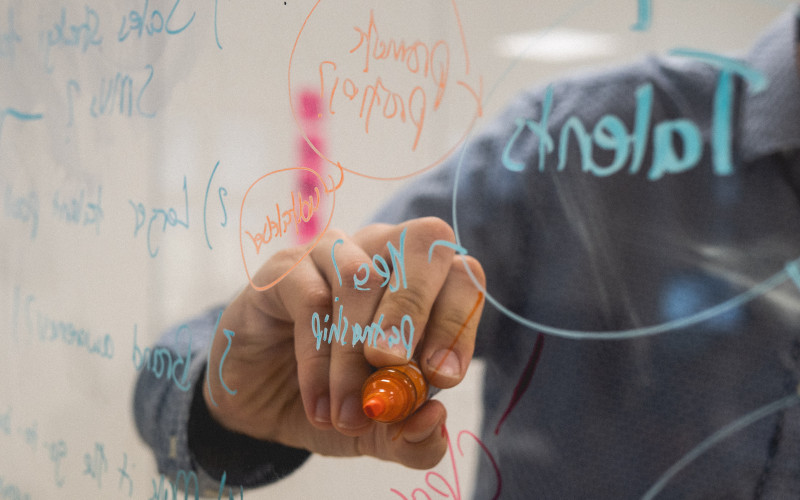 hand writing on a whiteboard