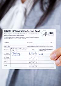 woman with vax card