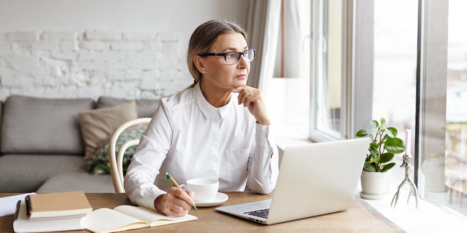 woman writing at desk