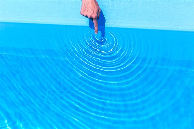 10 Ways to Multiply Your Campaign A finger dips into a bright blue pool causing circular ripples