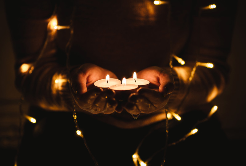 hands giving candles