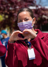 nursing making a heart with her hands