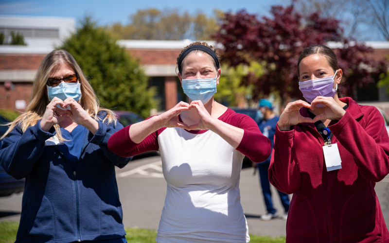 three nursings making hearts with their hands