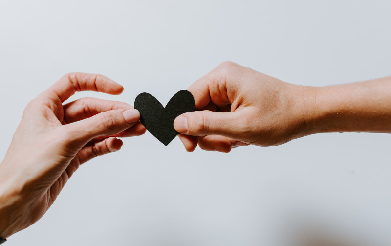 two hands holding heart two hands holding heart