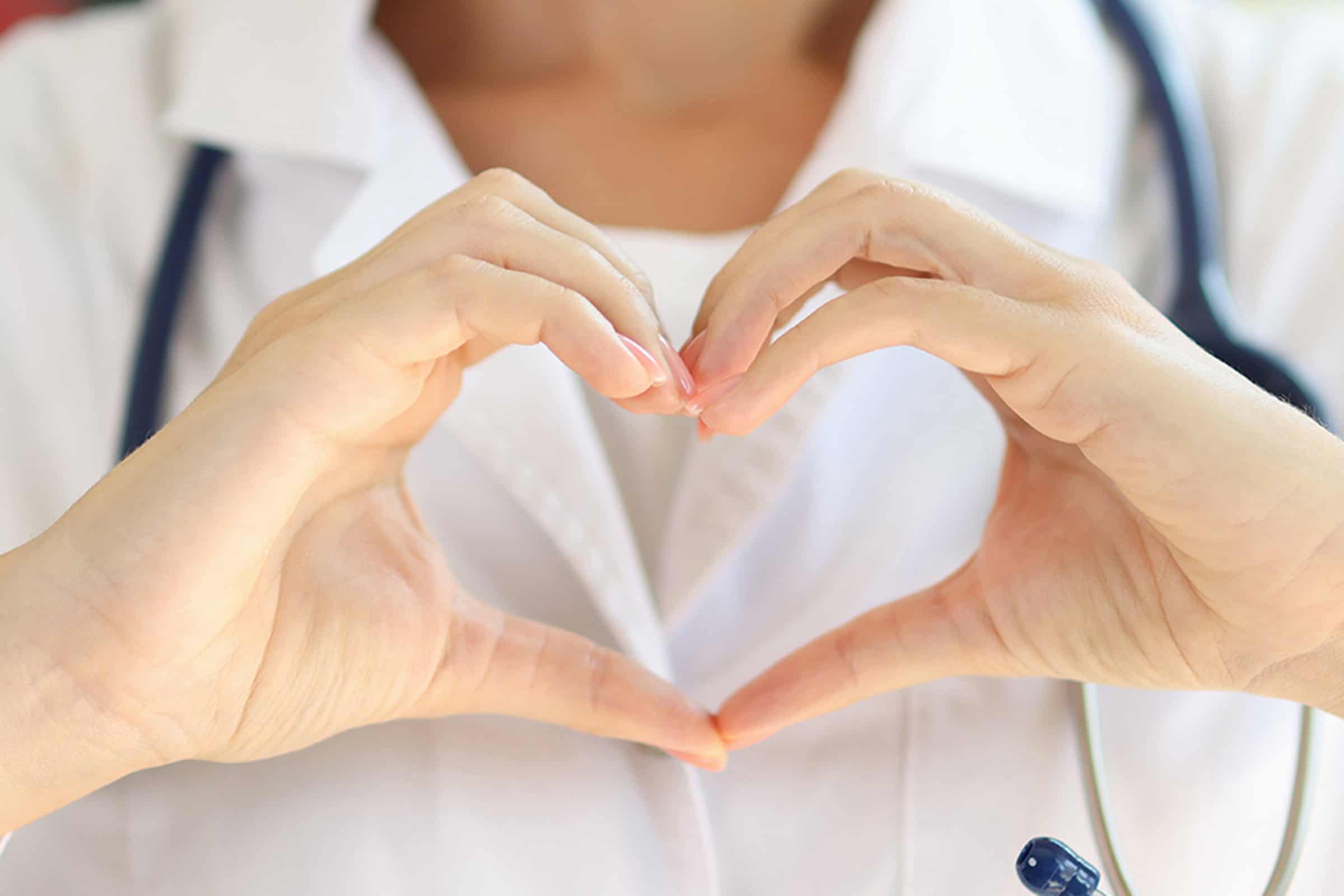 Doctor forming a heart with her hands