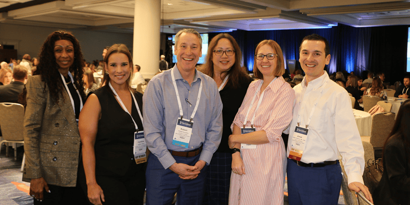 AHP members smiling at a conference