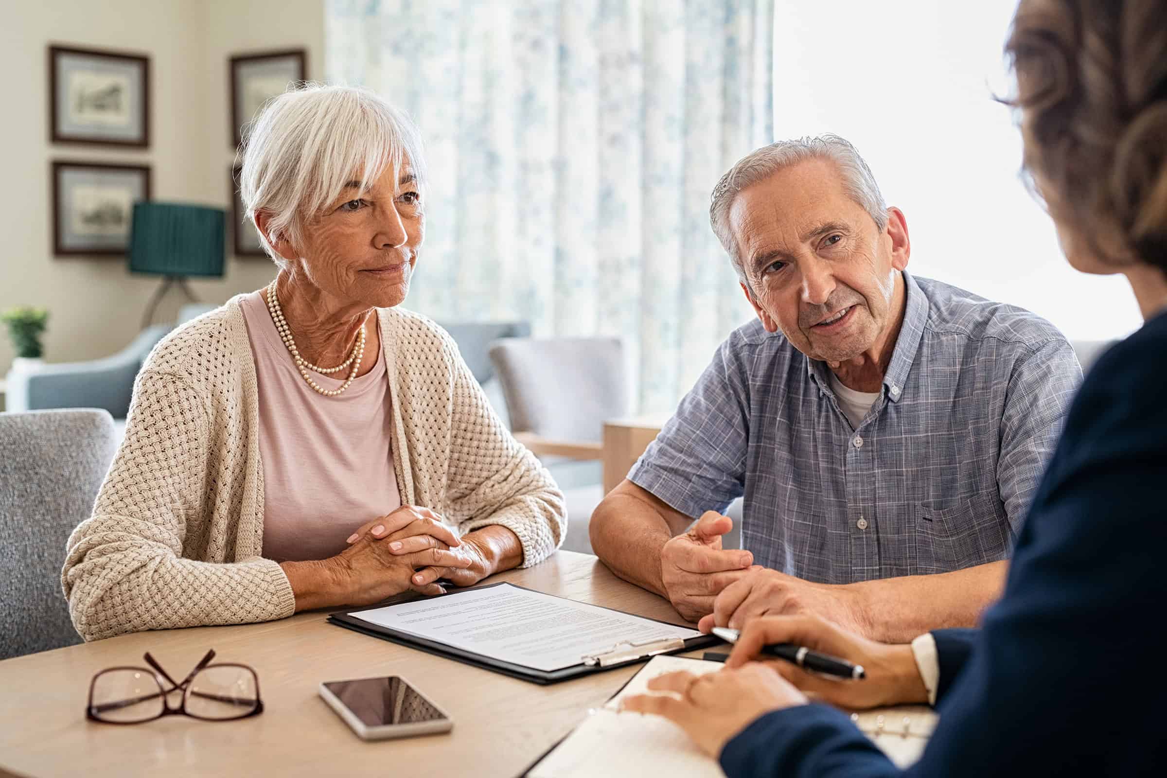 An older couple in conversation with a third person