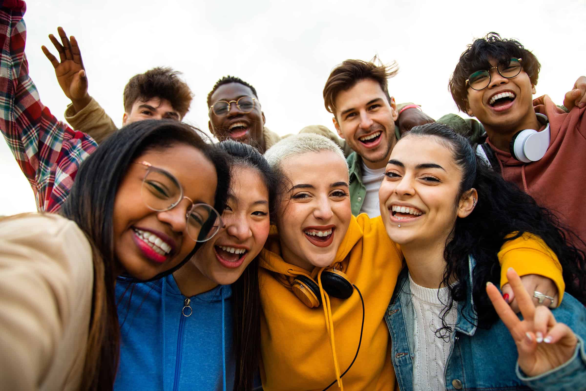 Group of multiracial young adults having fun outdoors
