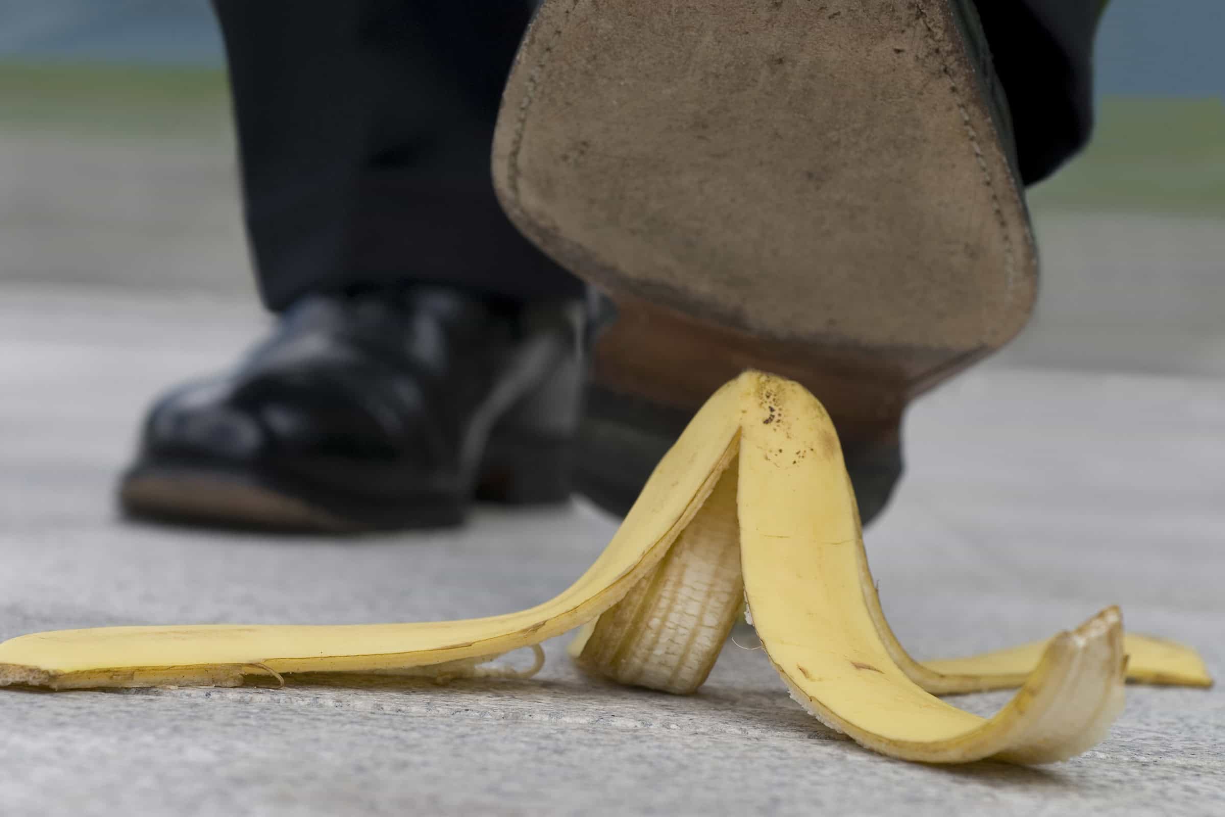 man stepping on banana peel