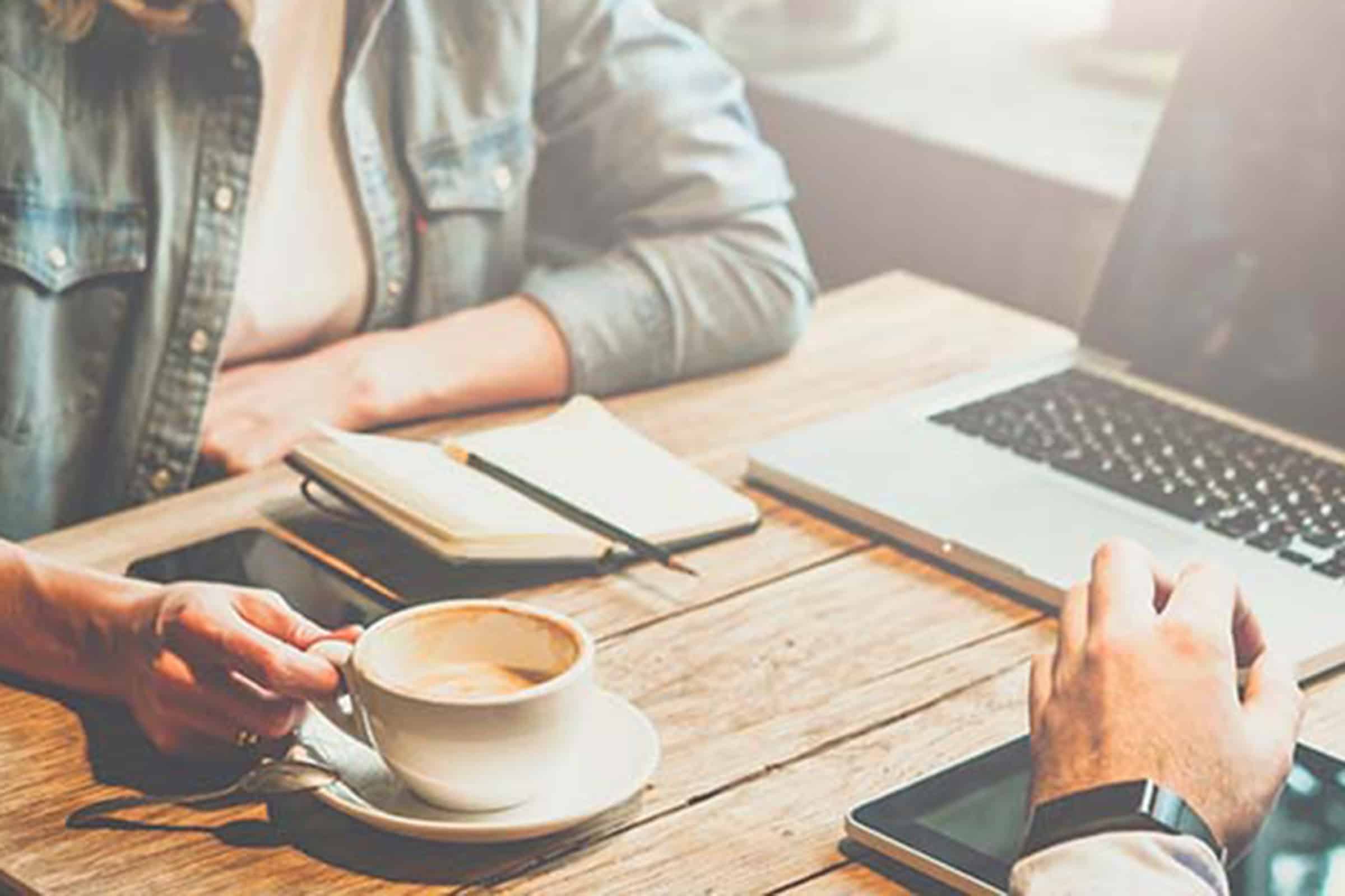 Two people meeting over coffee