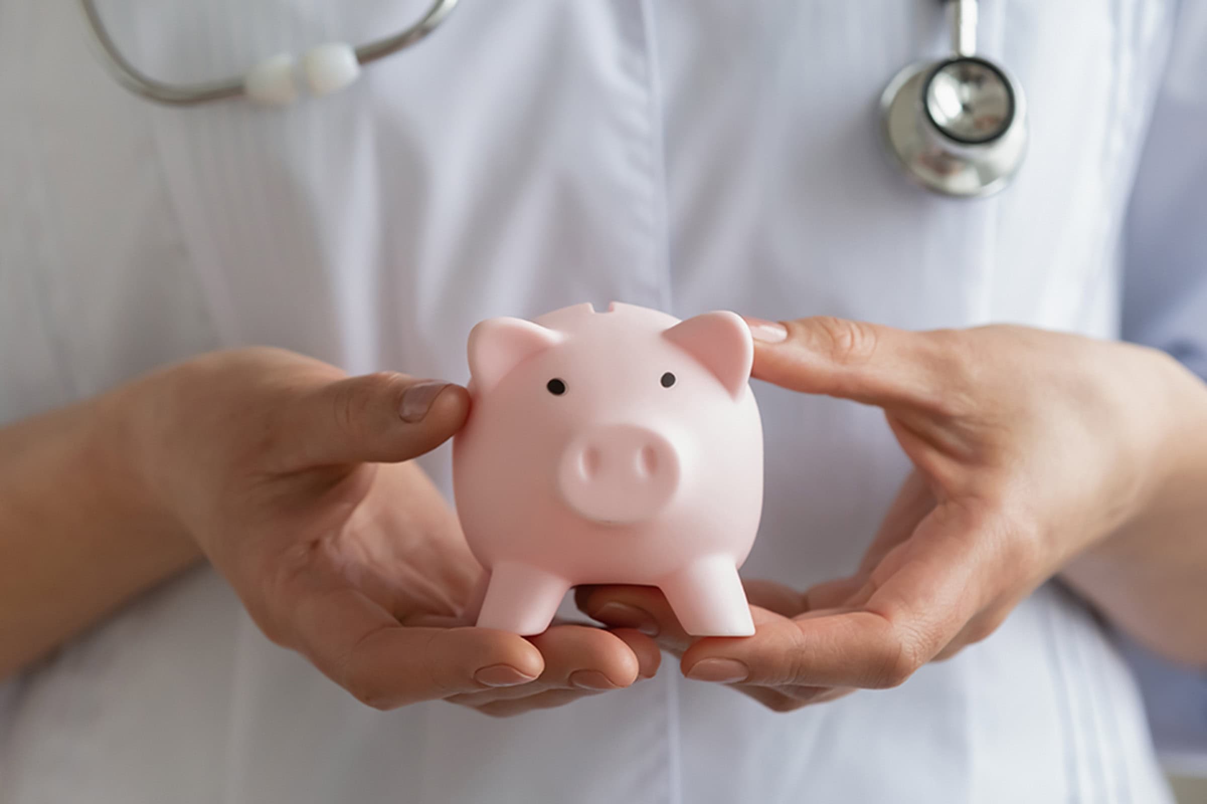 Nurse holding a piggy bank