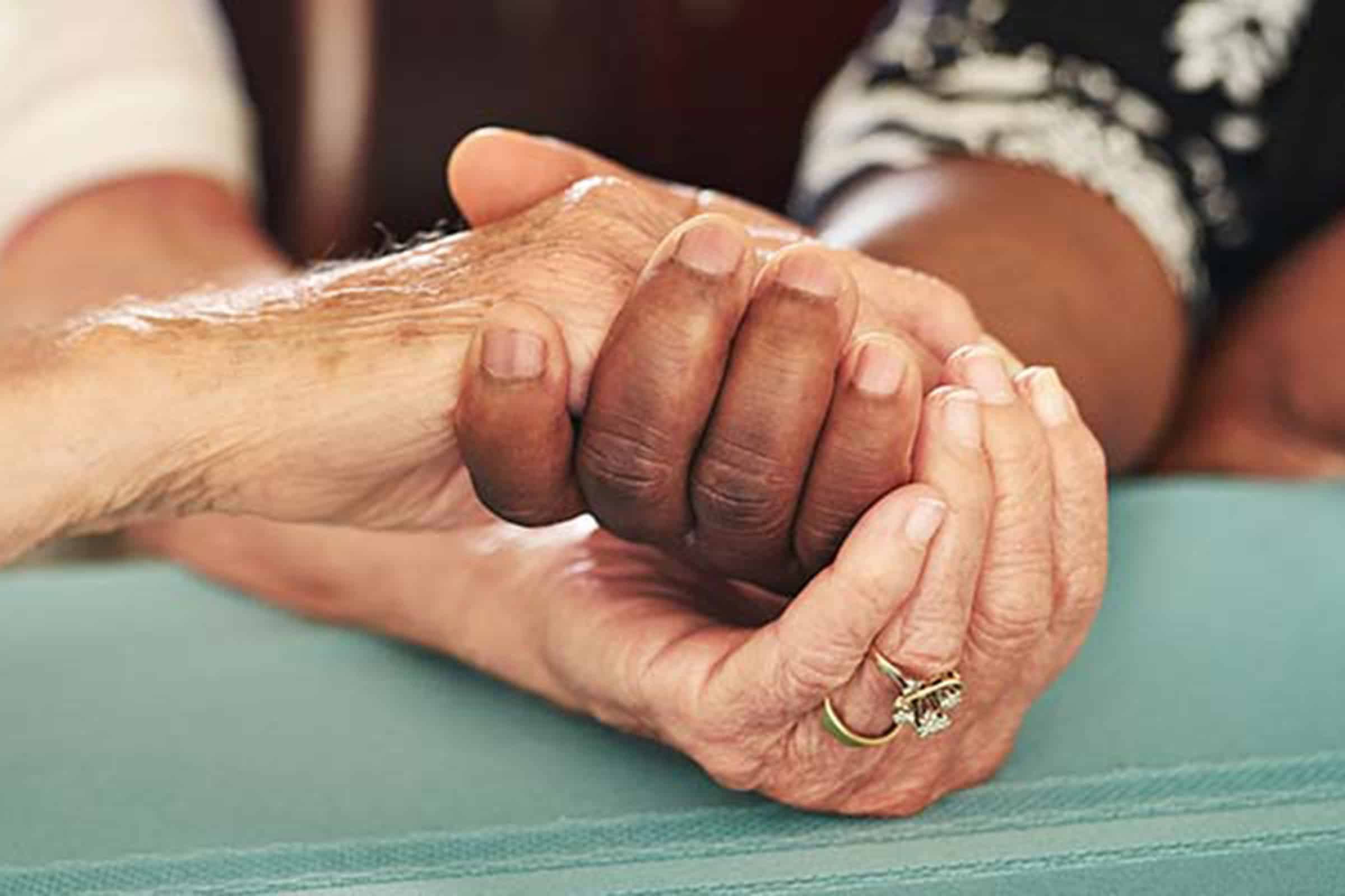 Old and young hands clasping