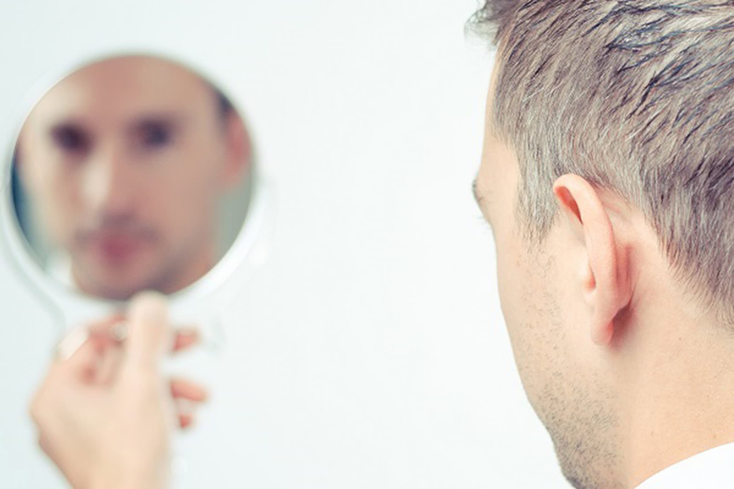 man looking in a mirror