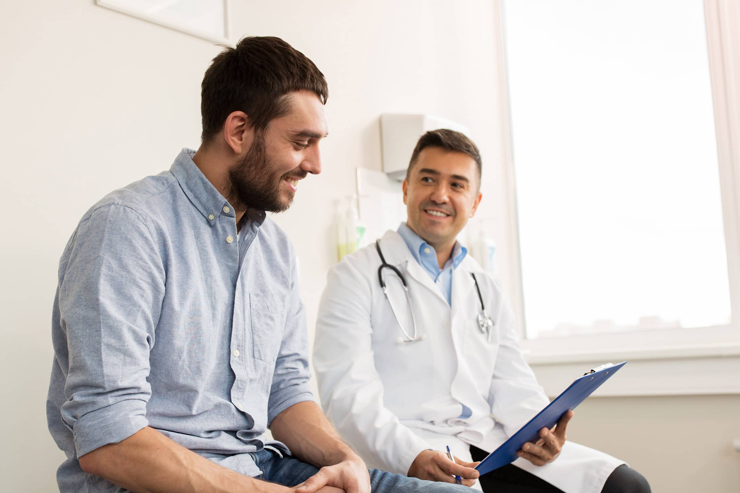Male doctor talking to male patient