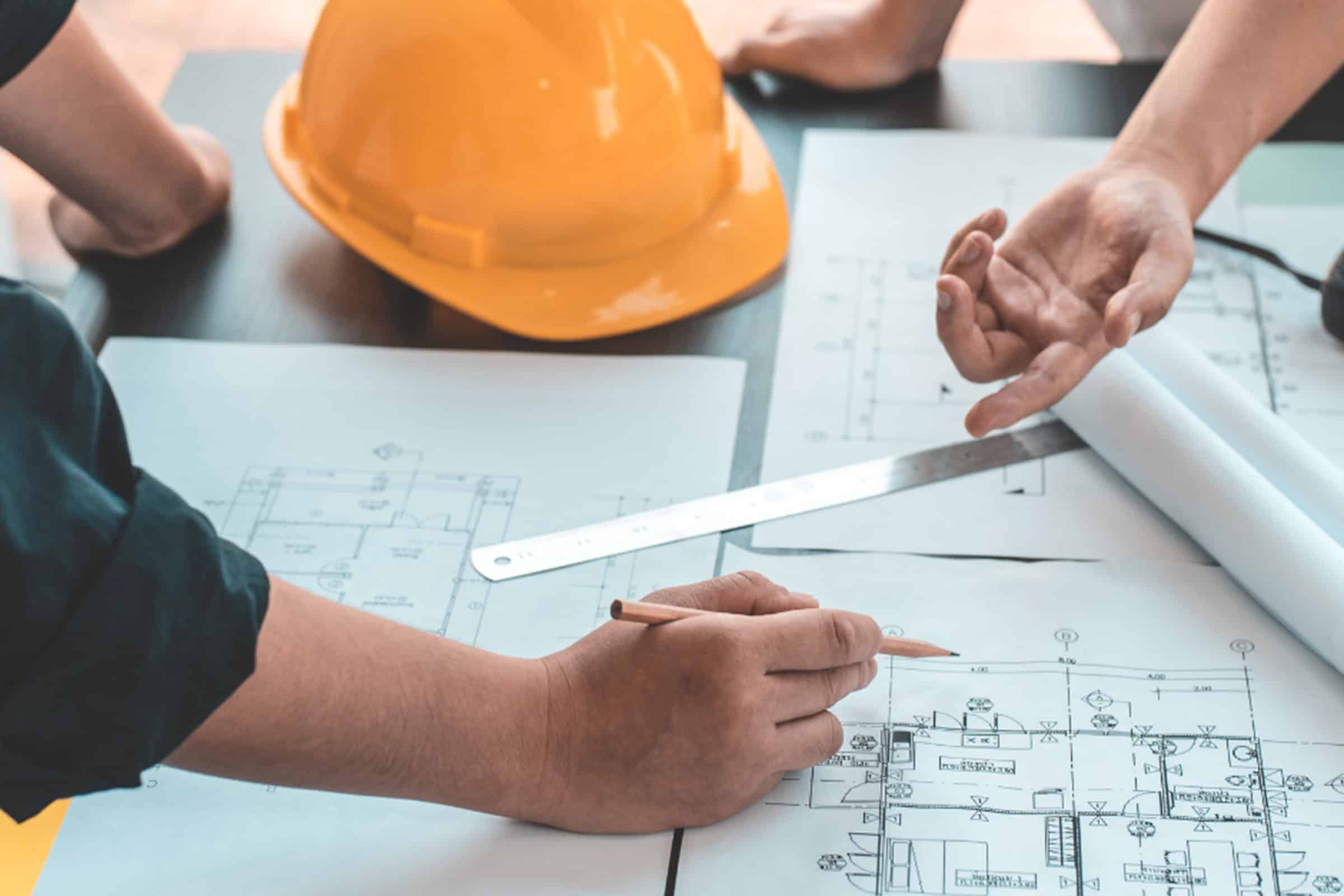 hands pointing to architect plans