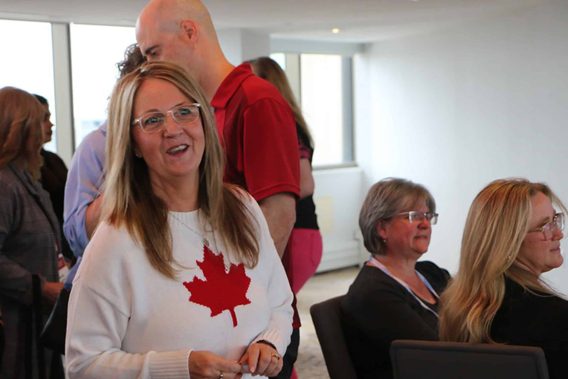 woman in maple leaf sweater