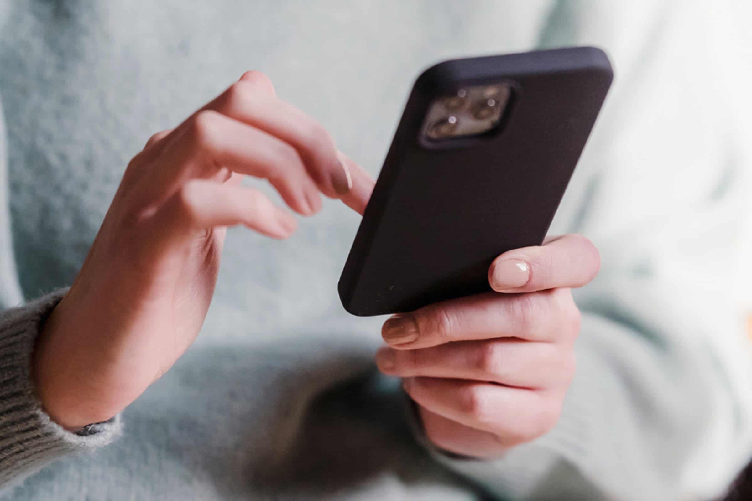 woman scrolling on a phone