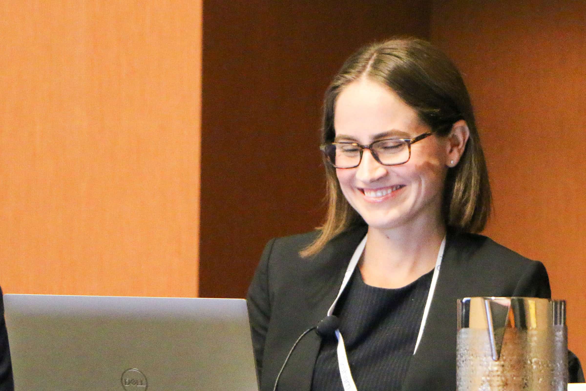 woman smiling at computer screen