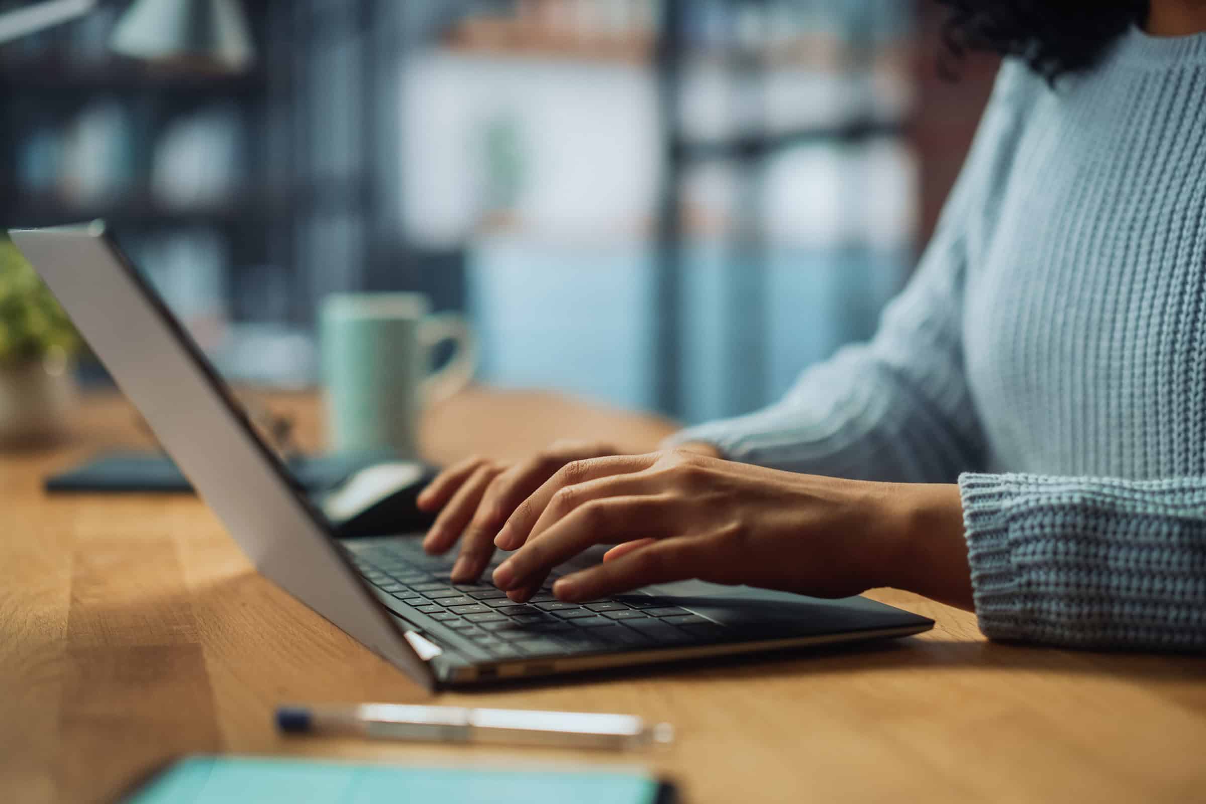 woman typing on laptop