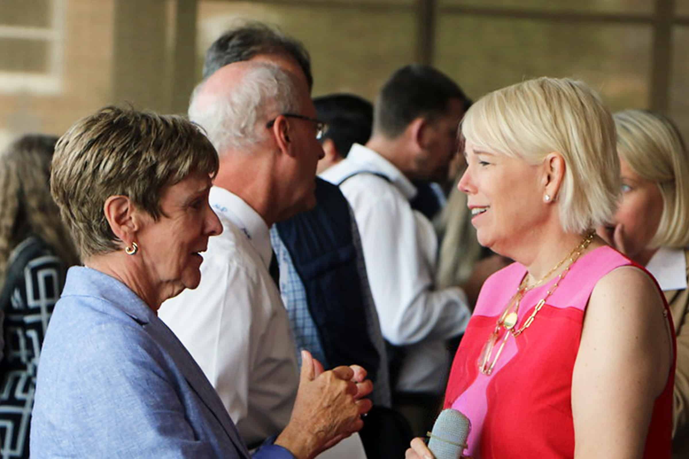 two women chatting at a reception