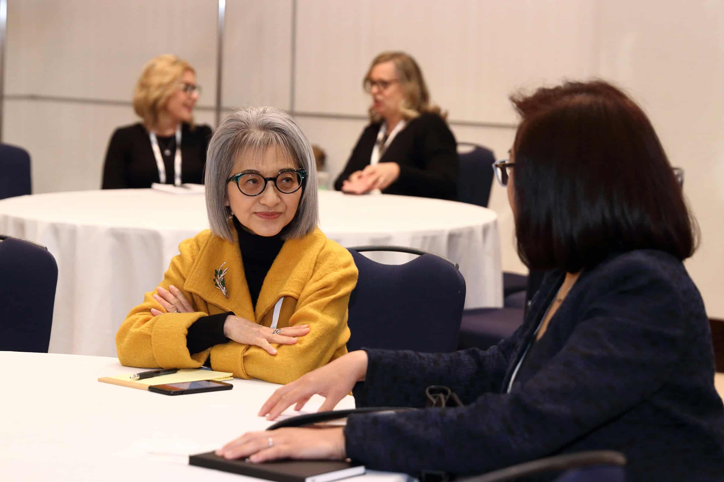 two women conversing at a table